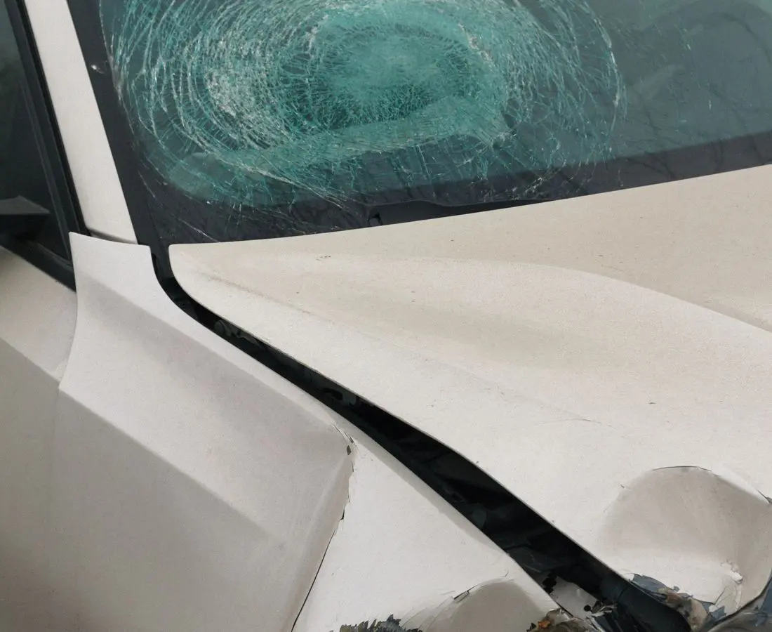 Car with shattered windshield after an accident — personal injury practice, Ave Maria Law Center